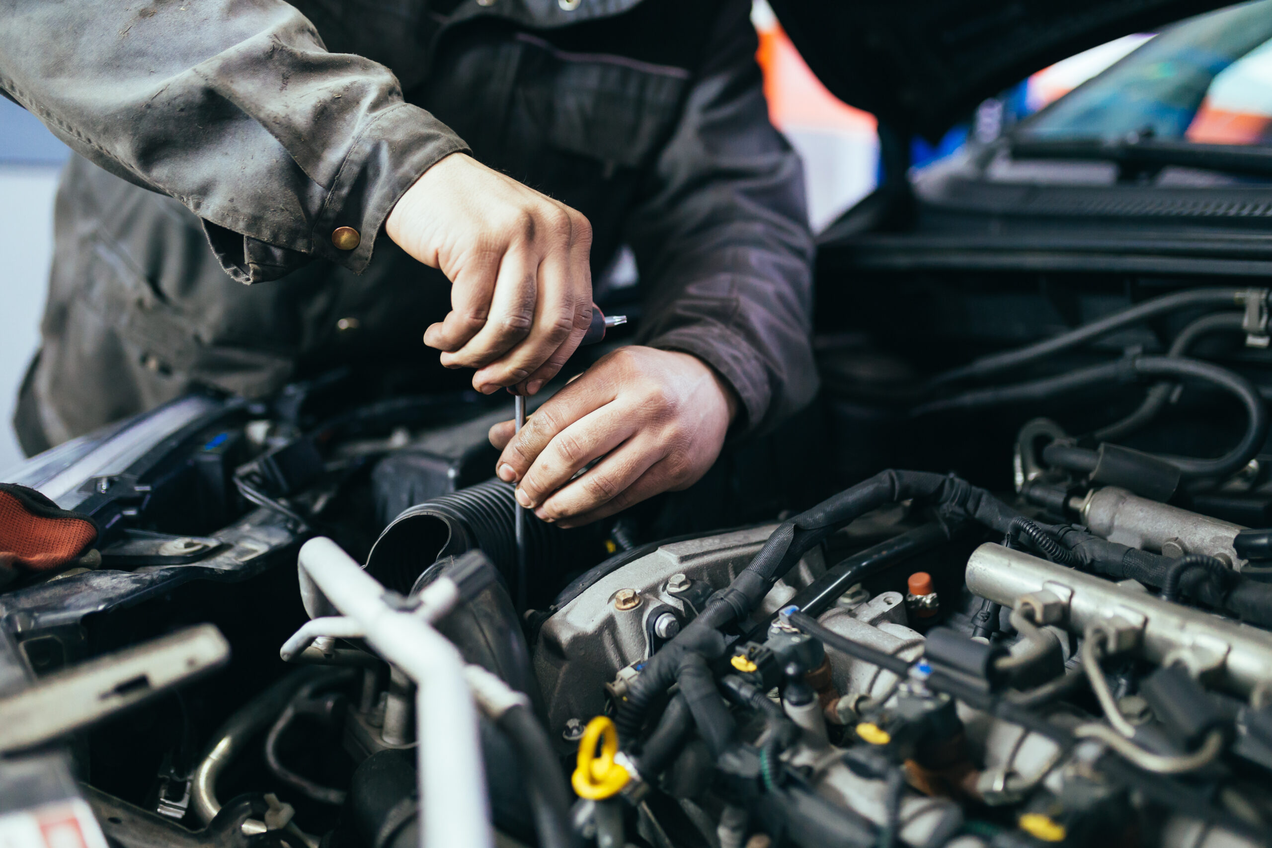 Auto mechanic repairing car. Selective focus.